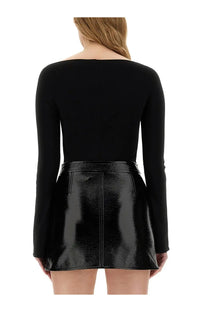 Courrèges women’s black body in jersey paired with a glossy patent leather skirt featuring a zipper and pockets