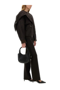 Black leather hobo bag with circular handle complementing Courrèges brown women’s bow neck bomber jacket
