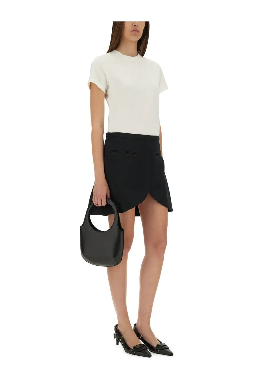 Black leather tote bag with circular handle and minimalist design paired with courrèges white cotton shirt