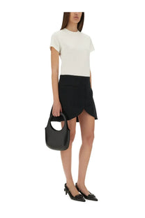 Black leather tote bag with circular handle and minimalist design paired with courrèges white cotton shirt
