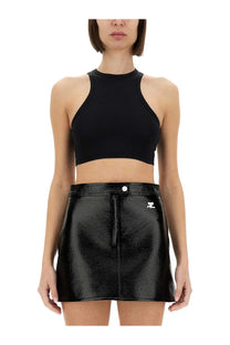 Black faux leather mini skirt with front zipper and white logo patch on right side from courrèges women’s collection