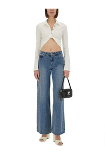 Black mini crossbody bag with silver logo and adjustable strap paired with courrèges women’s cropped white polo shirt