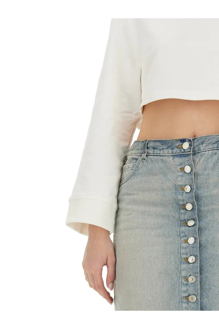 Light-wash denim skirt with a vertical row of white buttons down the front paired with courrèges white cropped sweatshirt