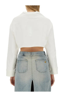 Courrèges women’s white cropped sweatshirt in long sleeve style paired with light-wash denim pants