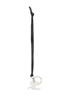Courrèges women’s black leather keychain with silver-tone metallic puzzle-piece charm and circular ring