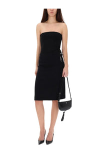 Black leather mini crossbody bag with tassel detail paired with courrèges women’s midi skirt black