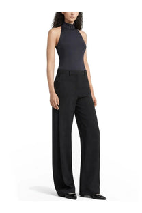 Courrèges women’s black pants shown with a black high-neck halter top featuring a sleek form-fitting silhouette and subtle texture
