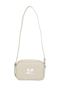 Cream-colored courrèges reedition naplack crossbody bag with minimalist logo patch and slender adjustable strap in beige