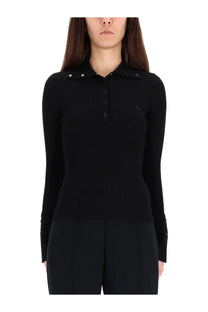 Black ribbed knit polo shirt with buttoned collar and cuffs featuring subtle courrèges branding on the chest