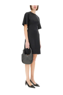 Black leather hobo bag with circular handle and minimalist logo detail paired with courrèges women’s short cotton dress black