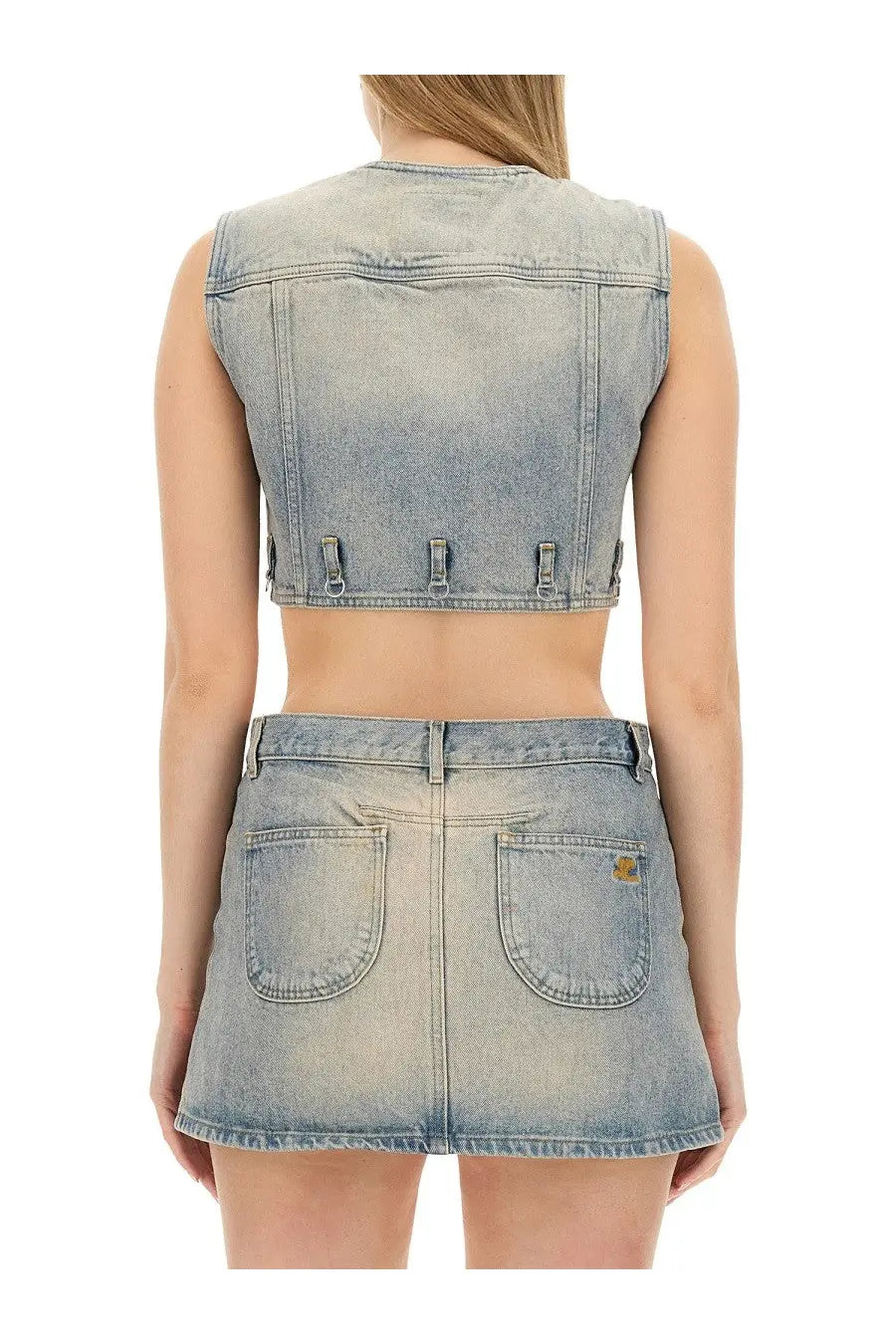 Back side of courrèges women’s light-wash denim sleeveless cropped vest with three adjustable metal tabs