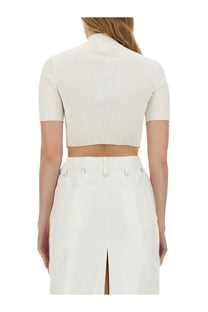 A courrèges women’s cropped white top featuring a ribbed knit fabric with short sleeves