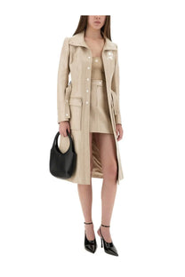 Beige leather trench coat with button closures and front pockets paired with courrèges vinyl mini skirt reedition beige
