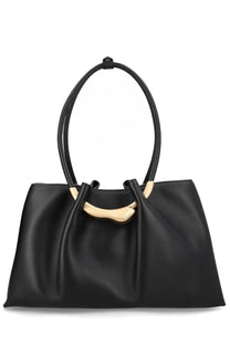 Cult gaia women’s black leather tote bag with gold tone circular handles and curved metal accent at the top
