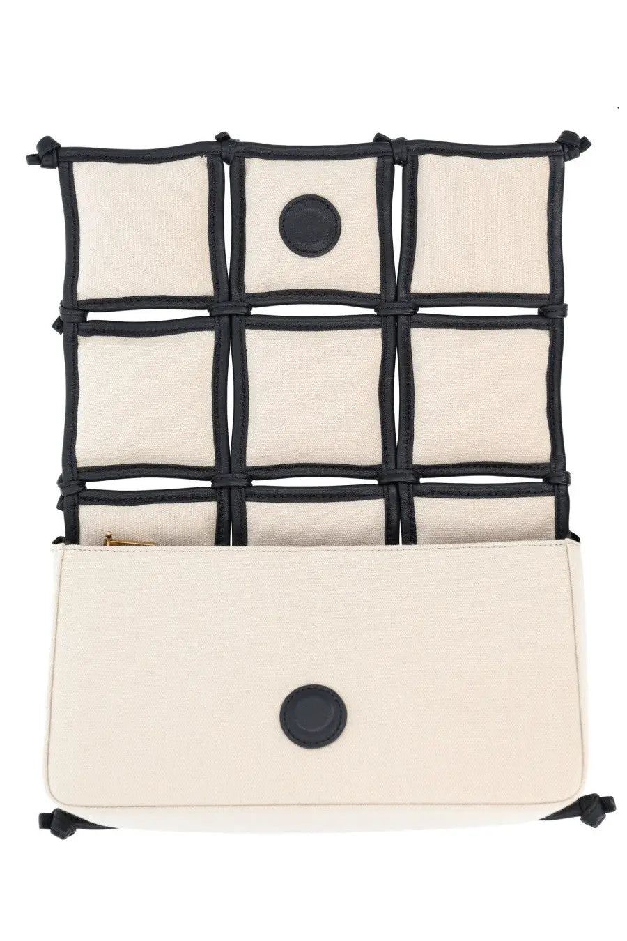 Cream-colored canvas crossbody bag with black woven straps and circular leather accents by Cult Gaia