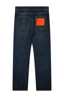 Back side of department five men’s dark blue denim jeans with a bold orange label on the right back pocket