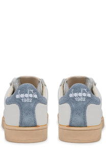 Back side of white and blue suede diadora men’s sneaker prestige plain used with vintage 1982 logo on heel