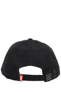 Back view of diesel men’s black cotton baseball hat with red diesel brand tag on the back