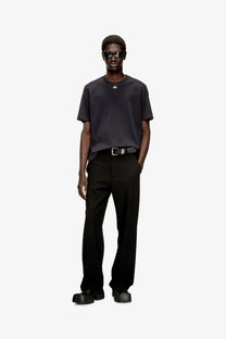 Black balenciaga belt with silver-toned logo buckle paired with diesel men’s black cotton blend shirt front view