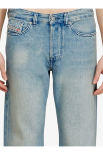 Back side of light-wash faded diesel men’s eeper blue denim jeans showing the brand label on the pocket