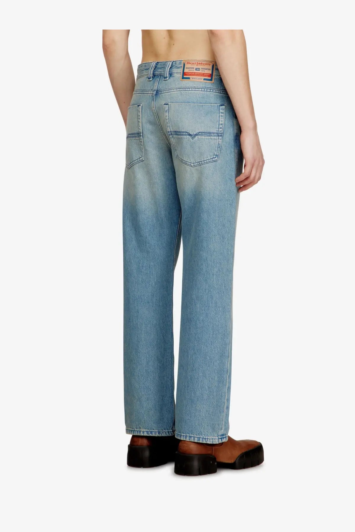 Diesel men’s eeper blue denim jeans in light-wash denim with a relaxed straight-leg cut and diesel label at the waistband