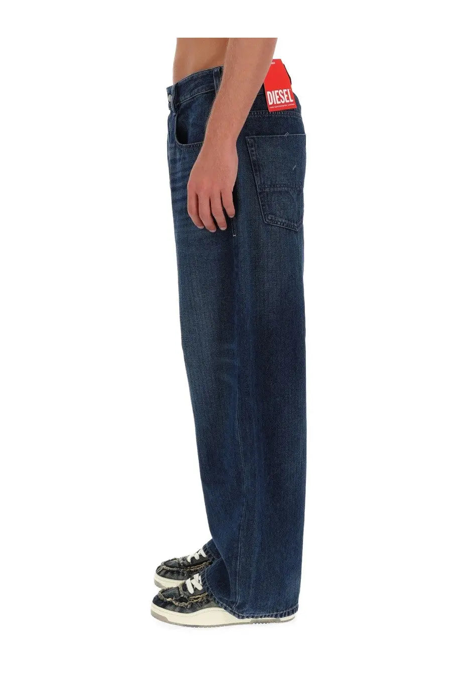 Dark blue denim jeans with a red diesel brand label at the waistband for men