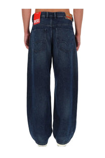 Dark blue denim men’s jeans with red diesel brand label at waistband in classic blue denim material