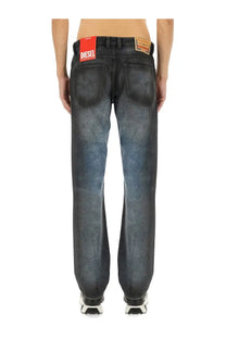 Back view of diesel men’s dark-wash denim jeans with faded distressed look and red brand label on waistband