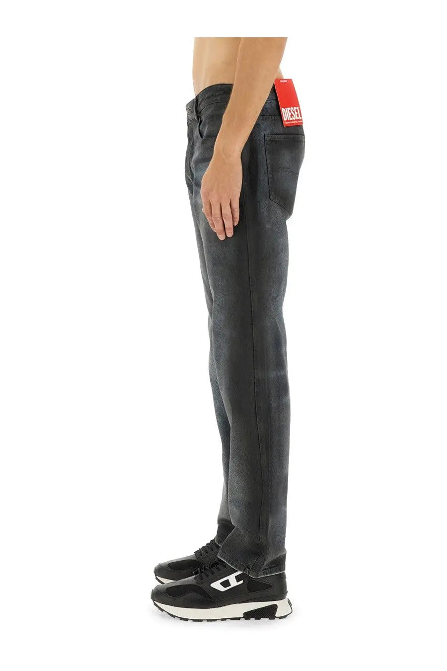 Dark-wash denim jeans for men by diesel with a red brand tag at the waistband in blue color