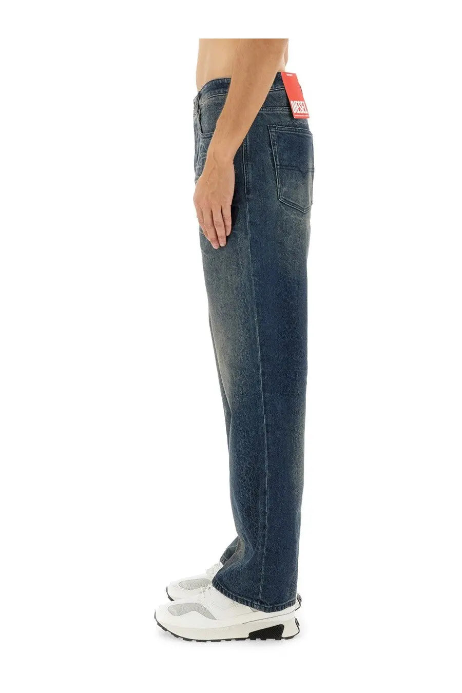 Dark-wash denim diesel men’s jeans with relaxed fit visible stitching and brand tag at the waistband