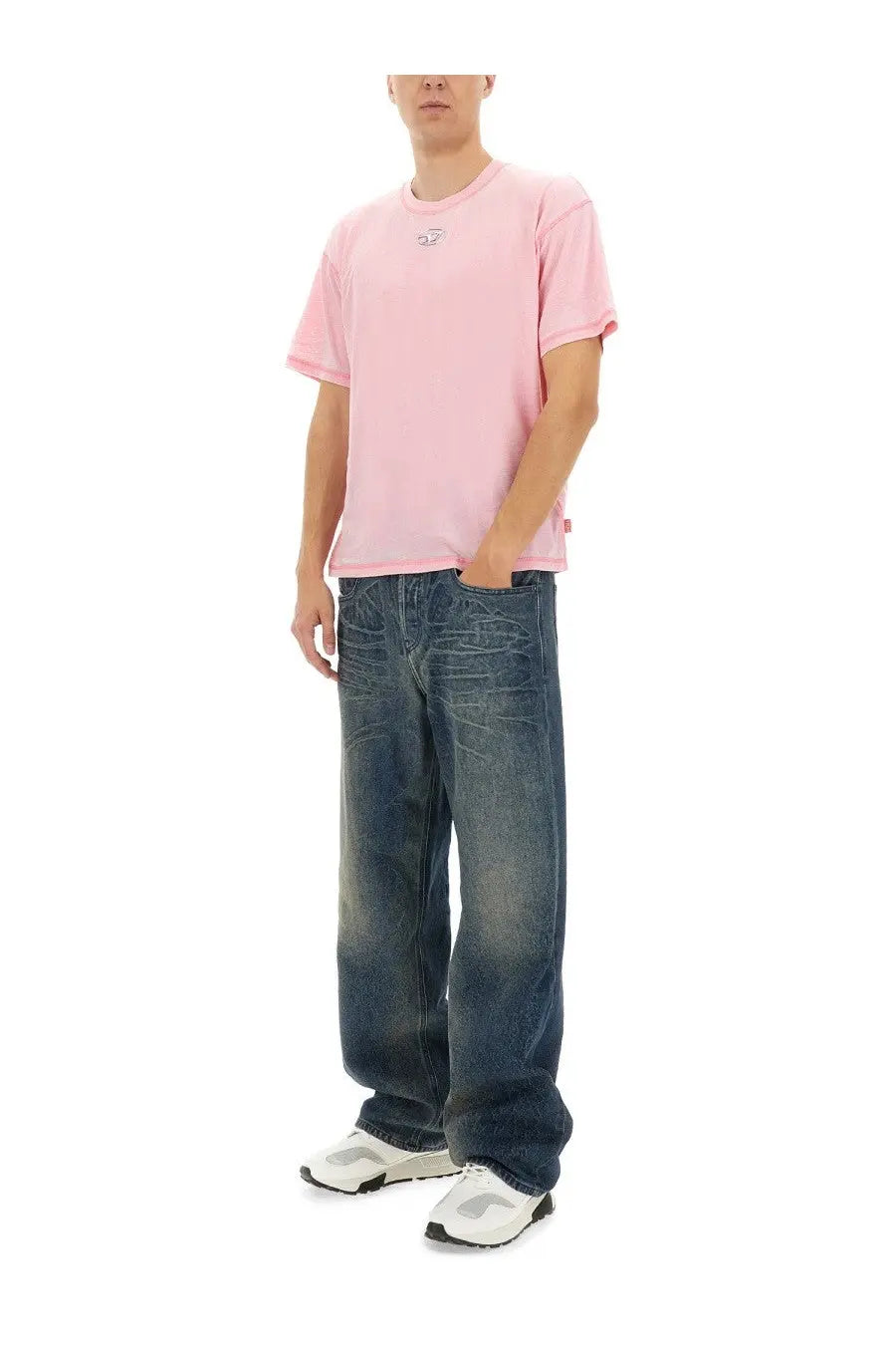 Pink short-sleeved t-shirt with small embroidered logo on chest paired with diesel men’s blue jeans