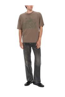 Olive green short-sleeved t-shirt with faded dark green graphic print paired with diesel men’s jeans eeper grey