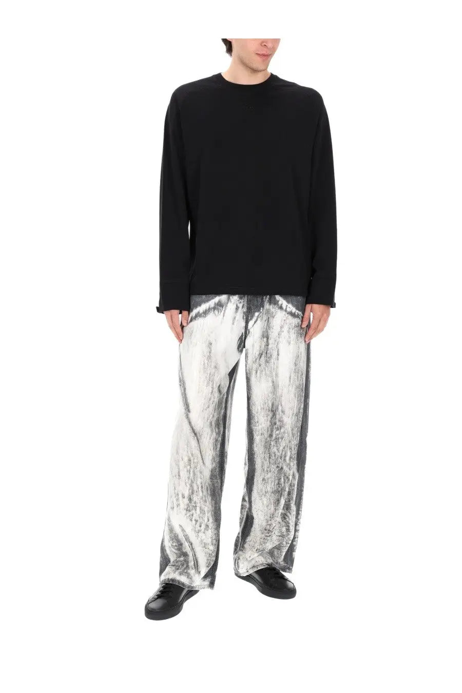 Diesel men’s jeans enim fsi blue paired with a black long-sleeved crew neck top and textured silver gray wide-leg pants