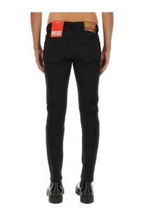 Diesel men’s jeans strukt slim fit black denim with a distinctive red brand label on the waistband visible from the back