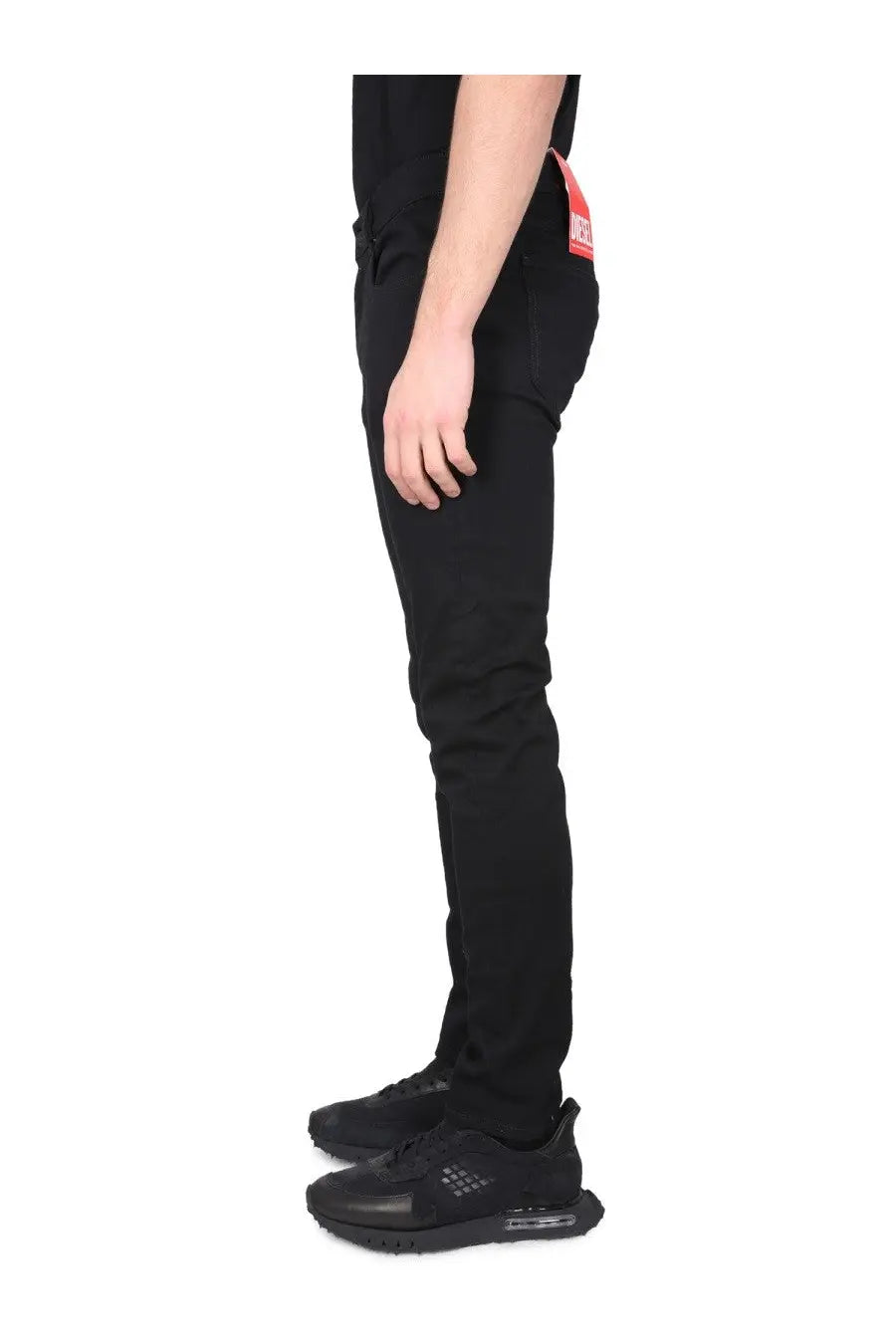 Diesel men’s slim-fit black denim jeans with a red waistband tag made from durable cotton blend fabric
