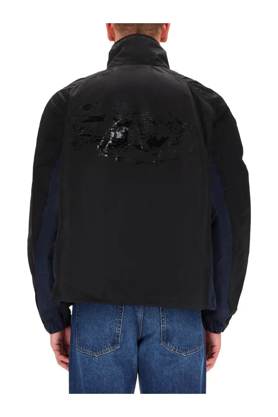 Back view of diesel men’s kaye black two-tone bomber jacket with glossy abstract graphic on navy blue back panel