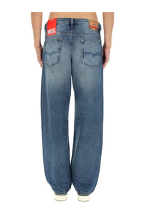 Blue denim jeans with faded wash and wide-leg cut showing diesel brand label on back waistband