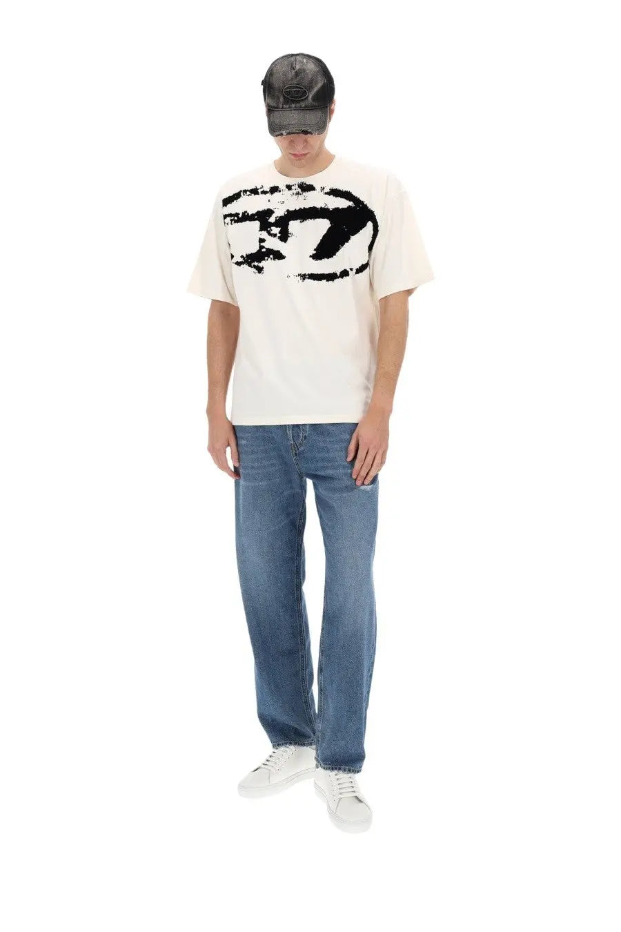 A cream-colored short-sleeved t-shirt with a bold black abstract graphic print featured with Diesel men’s Macs jeans blue