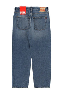 Blue denim jeans with faded wash and red diesel brand tag on waistband in diesel men’s macs jeans blue