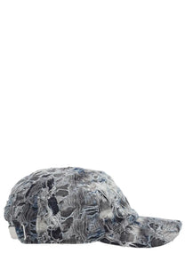 Diesel men’s pied baseball cap in faded blue and gray distressed denim with frayed edges and vintage patches