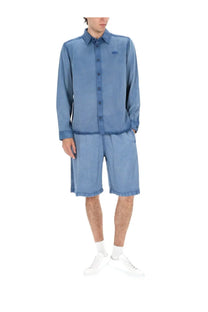 A light blue denim button-up shirt with a subtle logo on the chest for men by diesel shorts holg blue