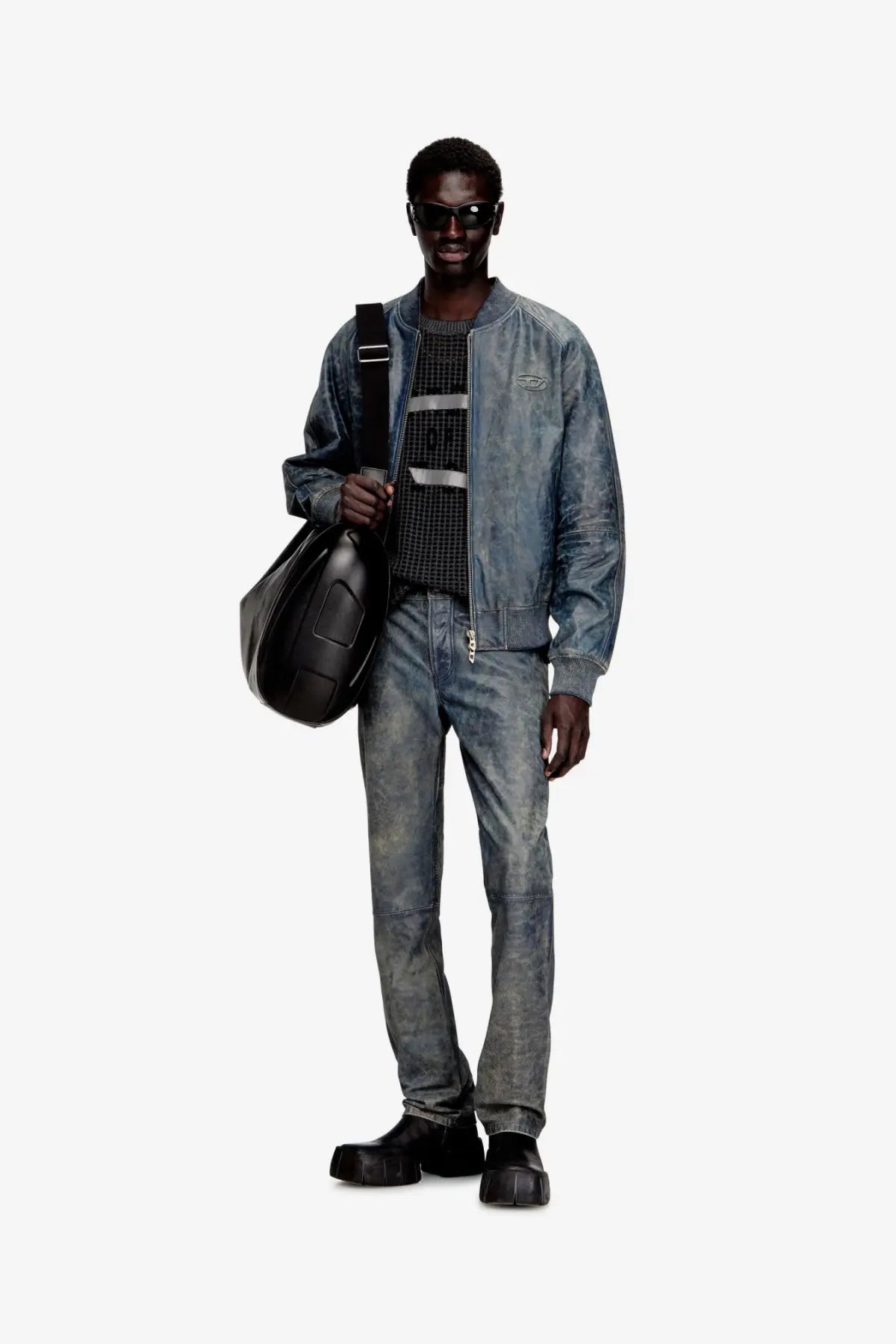 Black leather shoulder bag with structured minimalist design and visible stitching details next to diesel mens vyll qmbw leather trousers blue