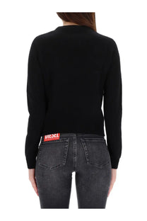 Back view of diesel women’s areesa black long-sleeved knit sweater with red logo patch on lower back