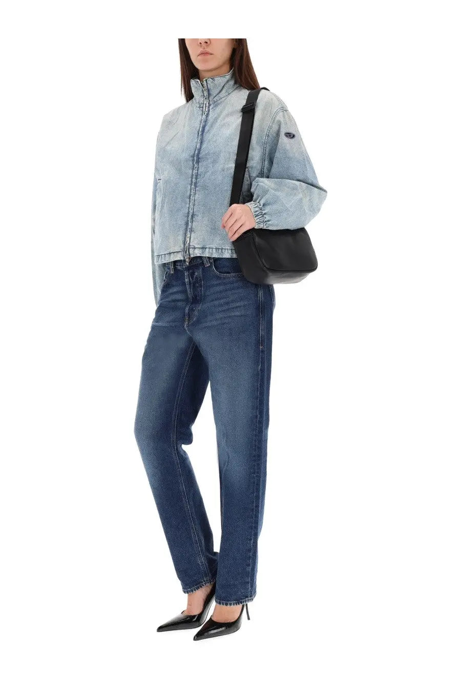 Black leather crossbody bag with sleek minimalist design paired with diesel women’s ark jeans blue