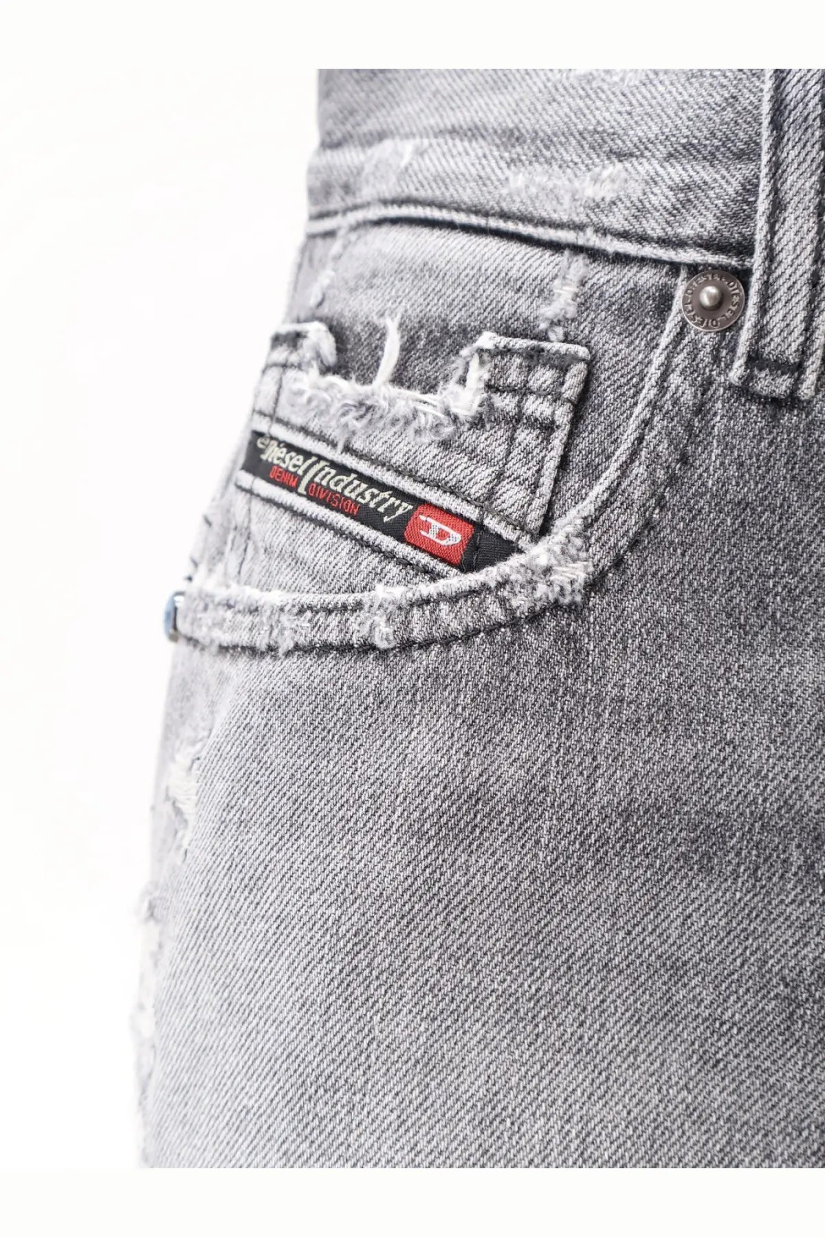 Distressed gray denim shorts with frayed pocket and black and red diesel logo patch on the back side