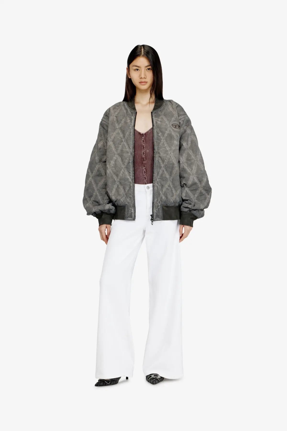 Diesel women cotton blend trousers white paired with a gray quilted bomber jacket with geometric pattern and black cuffs