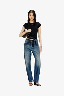 High-waisted blue denim jeans with faded wash and straight-leg cut paired with Diesel women’s black cotton shirt