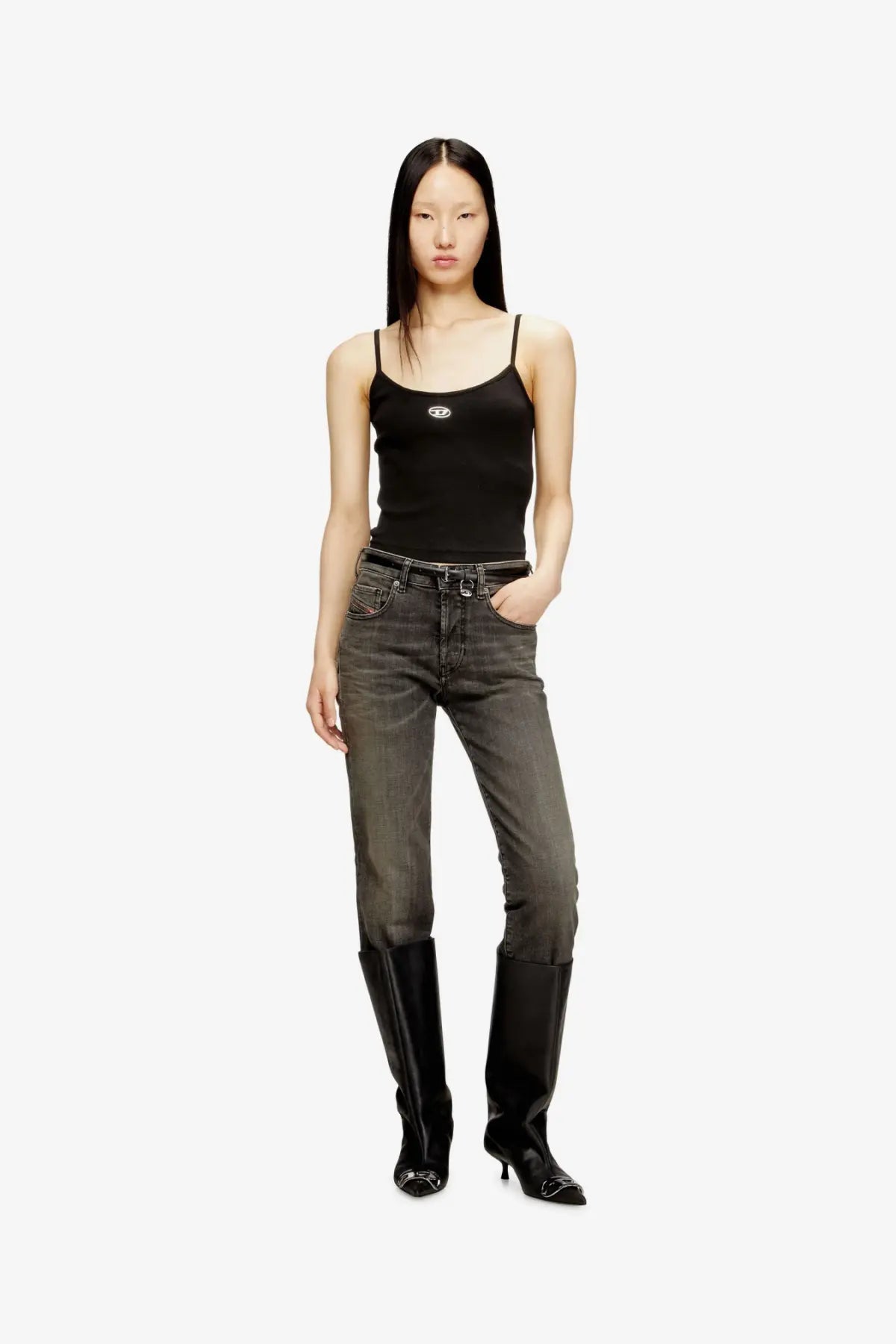 Black denim jeans with faded wash and classic five pocket design paired with diesel women’s black cotton tank top