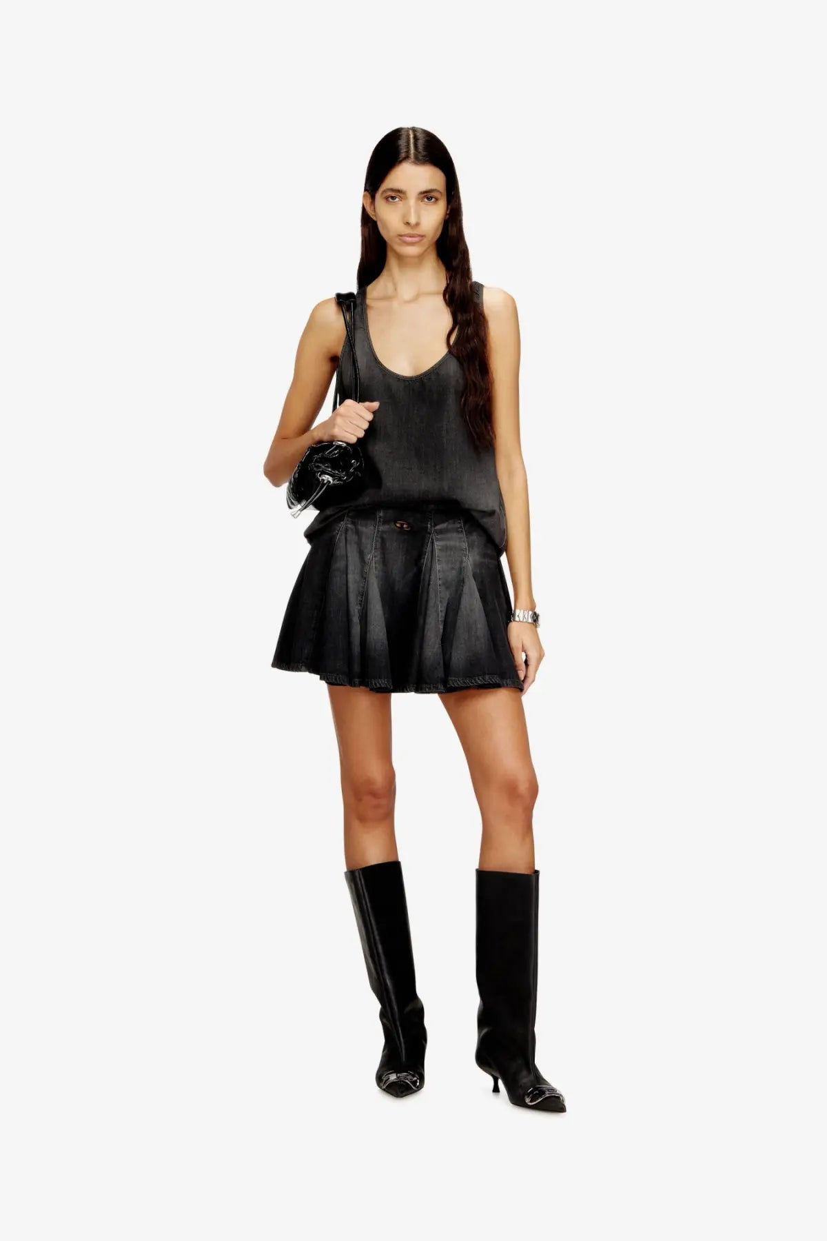 Black pleated mini skirt with a sleek glossy finish and subtle stitching details paired with diesel tank top
