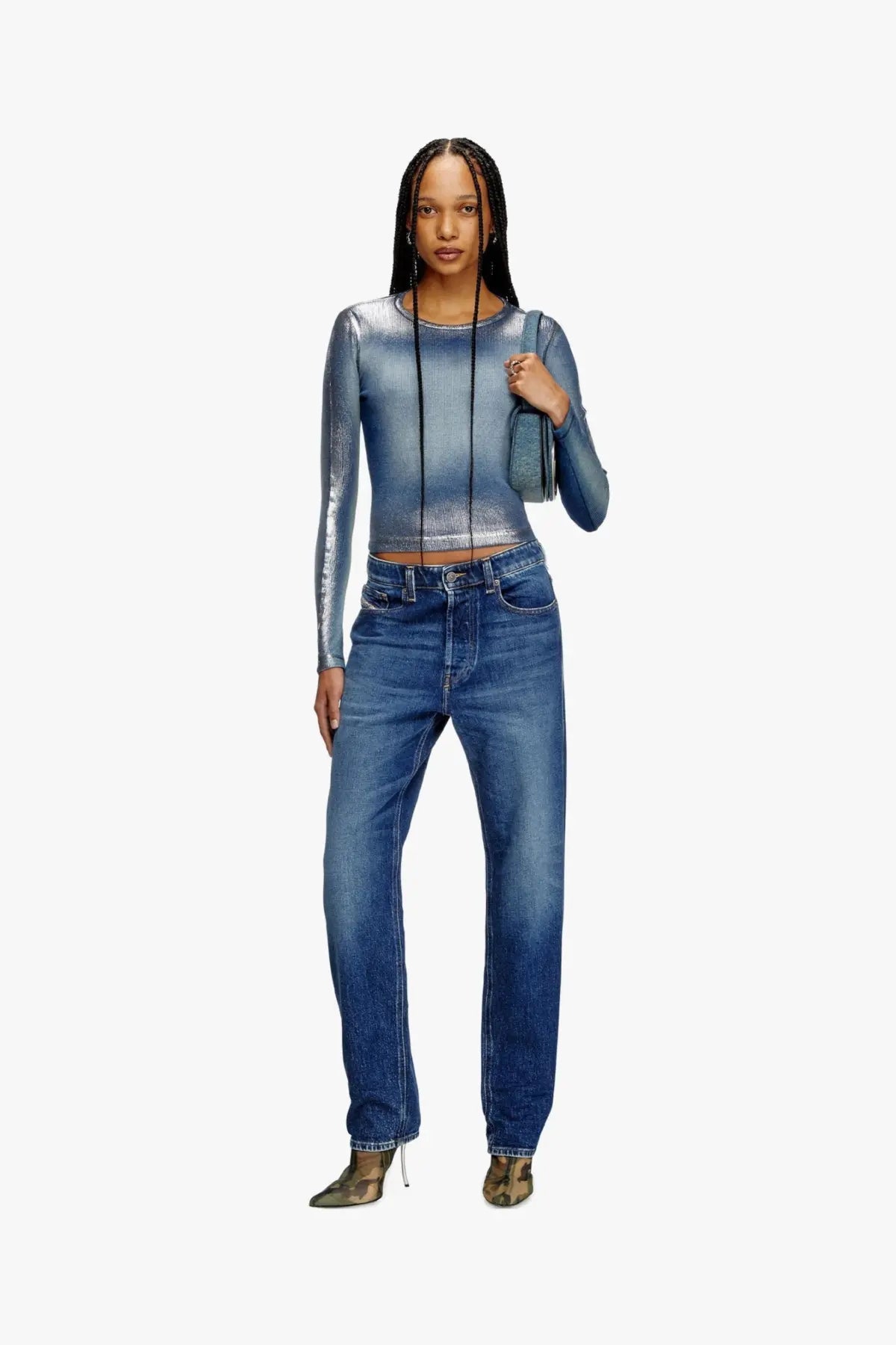 Diesel women’s denim shoulder bag blue shown with a shimmering metallic blue long-sleeved crop top with gradient effect